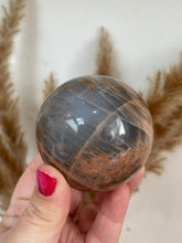 Load image into Gallery viewer, Peach and Black Moonstone Sphere
